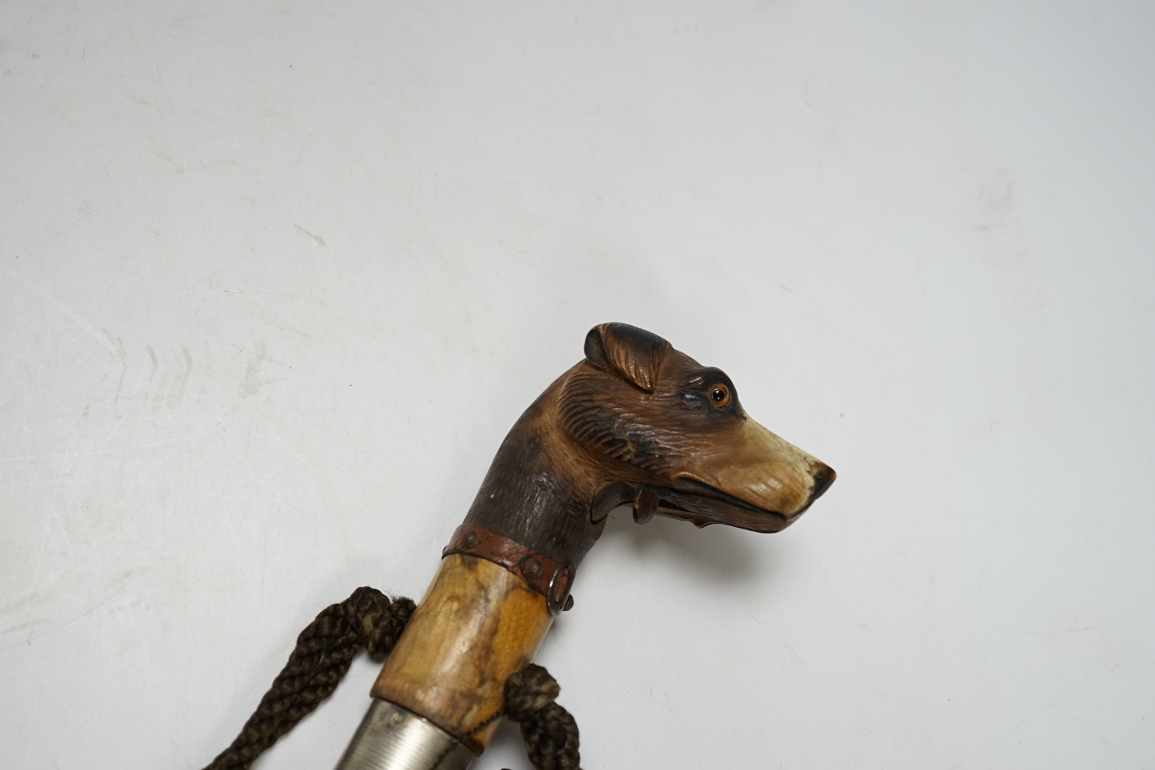 A Victorian silk parasol, carved ‘dogs head’ handle with articulated jaw and telescopic bamboo cover